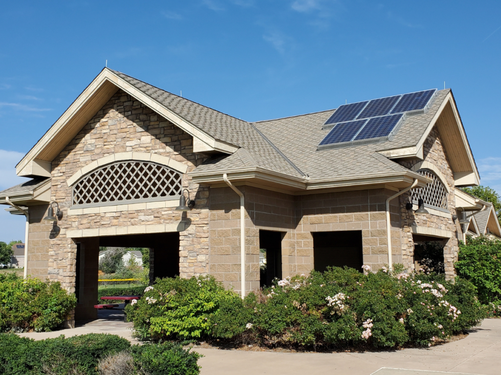 A park pavilion with shrubs and solar panels