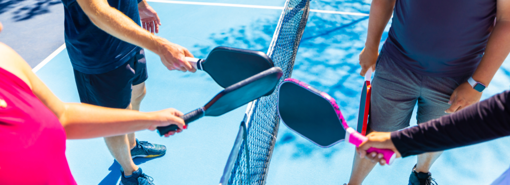 4 pickleball players on a pickleball court