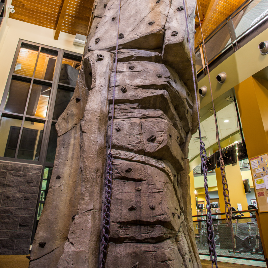 Indoor Rock Climbing Wall | image of the rock climbing wall at the trails recreation center with the ropes tied up