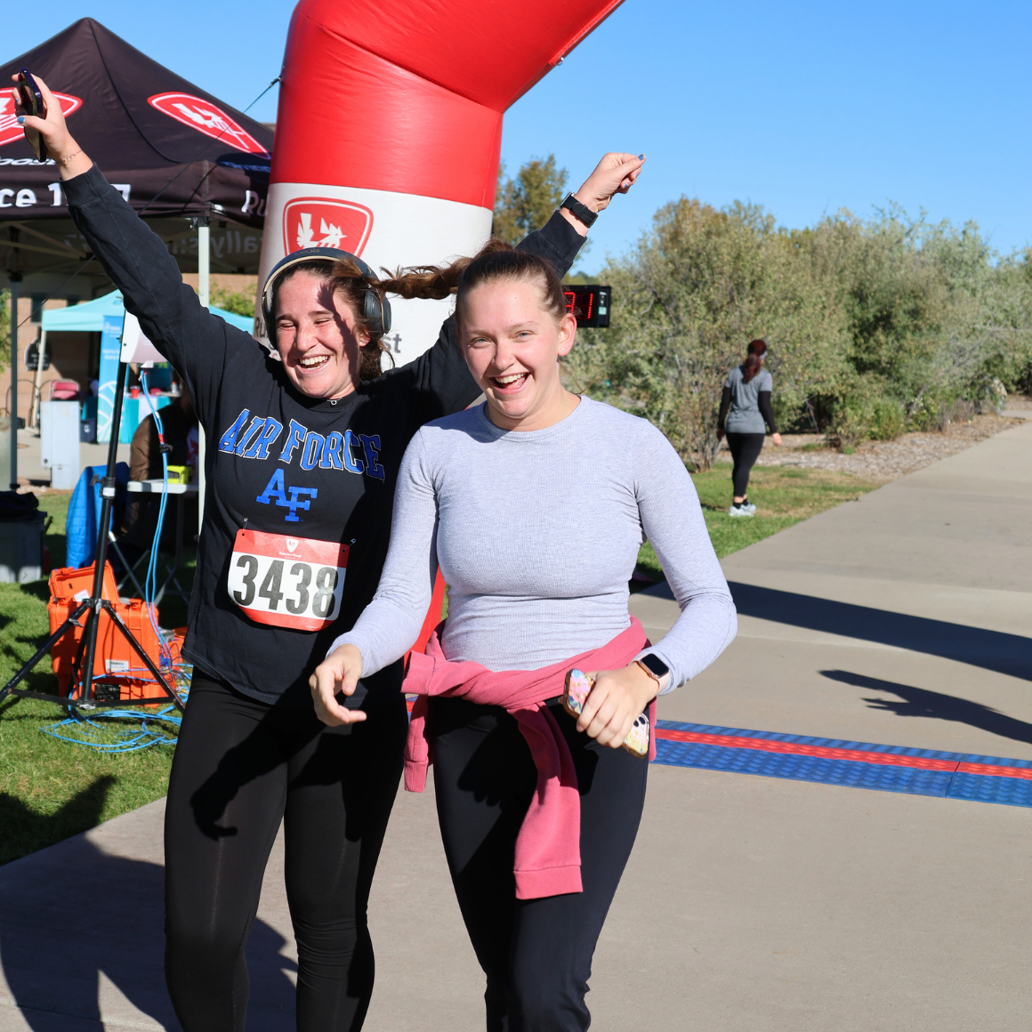 Trails 5k | two teenagers celebrating after crossing the finish line