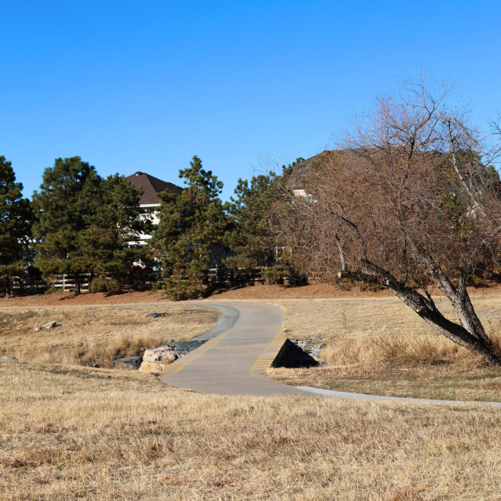 Piney Creek Trail at Cherokee Trail Park | trail going over a river with native grasses