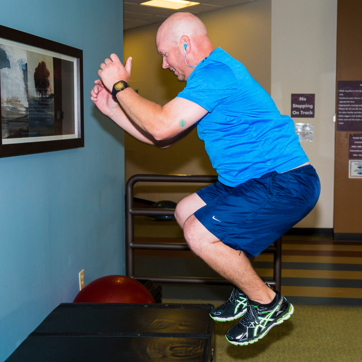 Fitness - man jumping onto Boxes