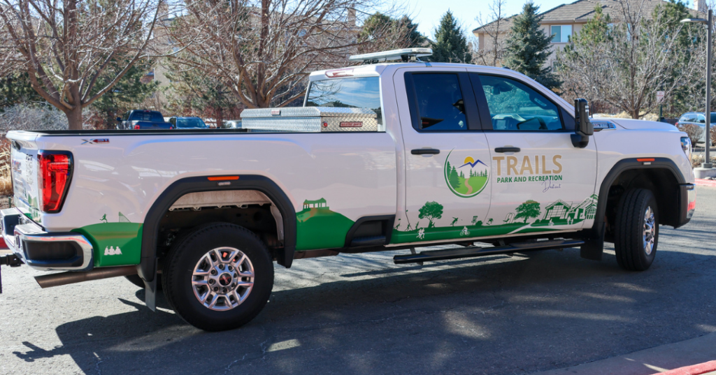 The new truck wrap on TPRD's service fleet includes the logo, website, and a graphic across the bottom featuring Trails Recreation Center, Lookout Pavilion, and the outdoor pool.