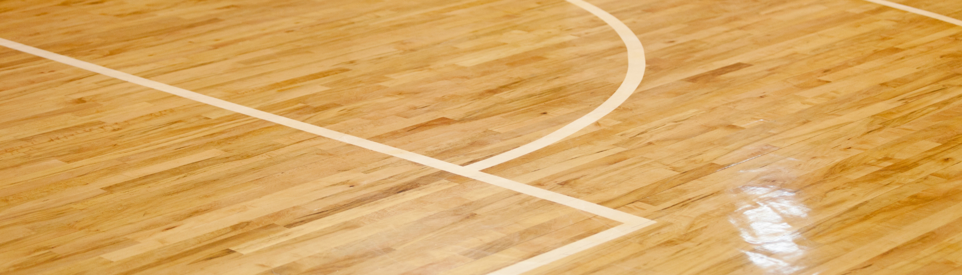 Adult Basketball League Header | shot of a wood basketball court floor