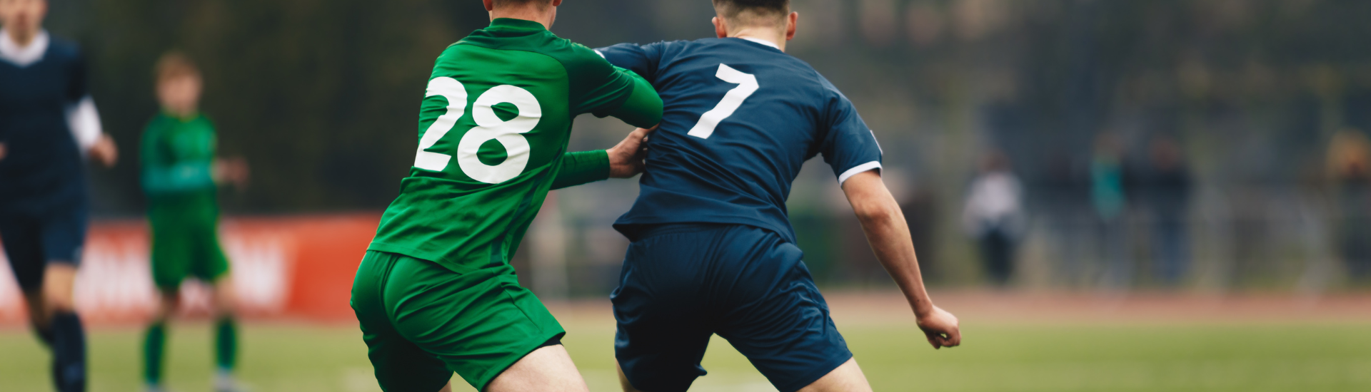 Adult Sports Soccer League | two soccer players from opposing teams pushing each other while playing