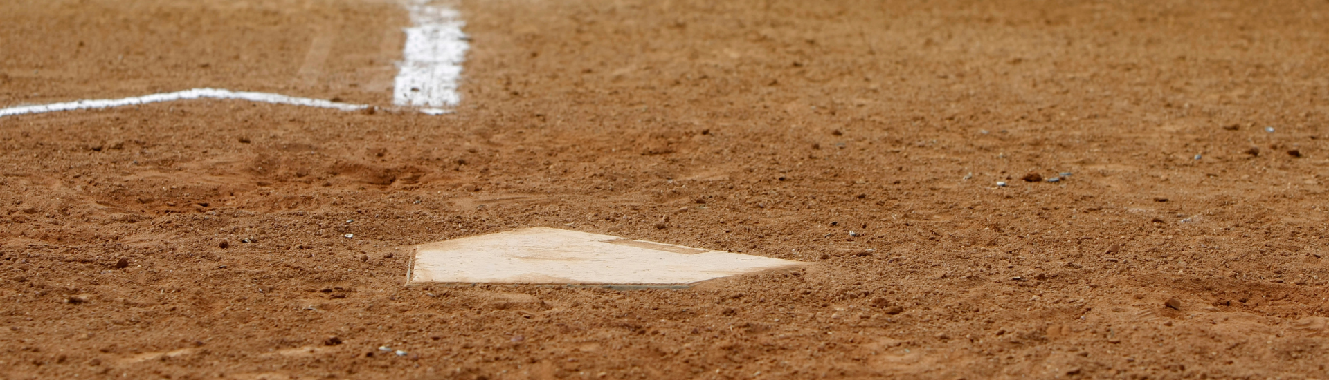 Youth Baseball Page | Dirt baseball field with home plate at the center.