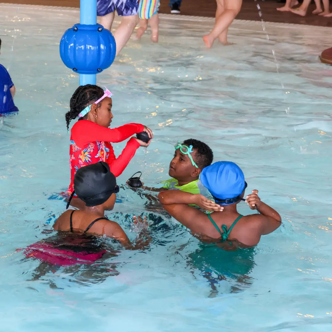 Dive for Gold | a group of 4 kids comparing the coins they've collected in the water