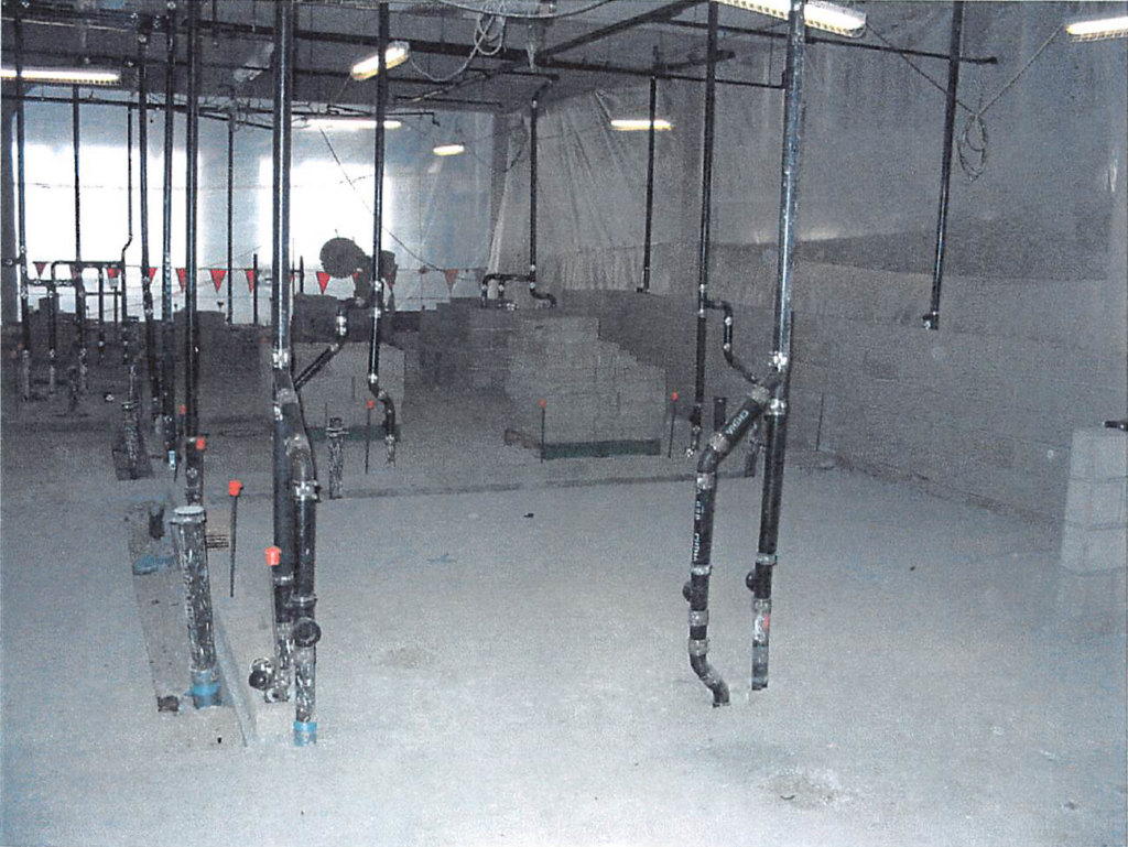 February 2004 Locker room concrete floor slab poured, with plumbing rough in progress