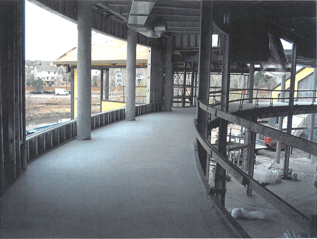 March 2004 Running track deck concrete fill poured. View toward climbing wall