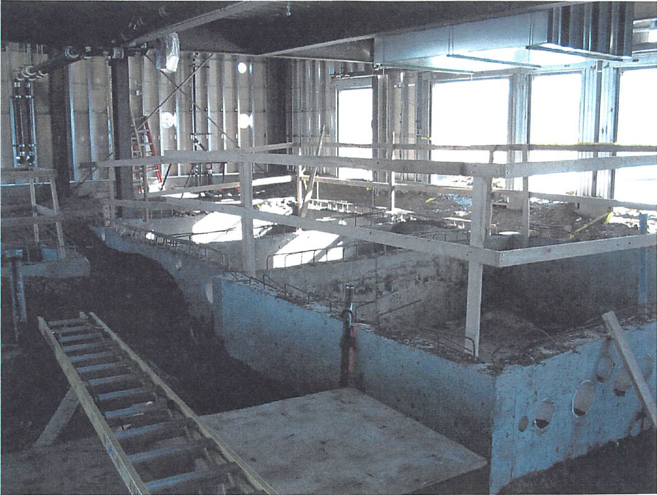 January 2004 Surge and backwash tanks have been poured in the pool mechanical room, with plumbing rough in progress